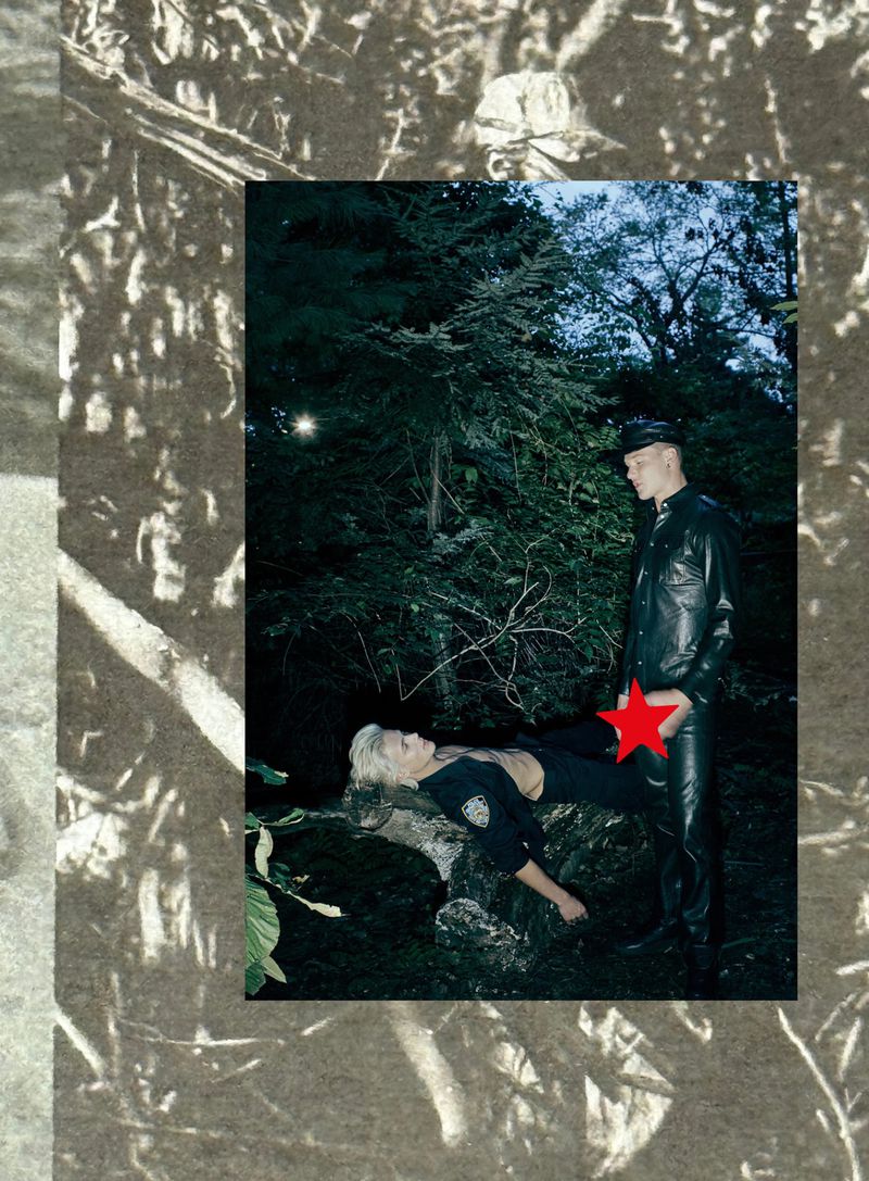 A man in a leather outfit stands over a woman lying on a log in a dark forest setting, creating a striking and edgy composition.