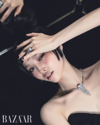 Close-up portrait of a model wearing high jewelry diamond necklace and rings against a dark background for Harper's Bazaar Korea