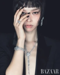 Close-up portrait of a model wearing diamond jewelry and black blazer against a dark background for Harper's Bazaar Korea.