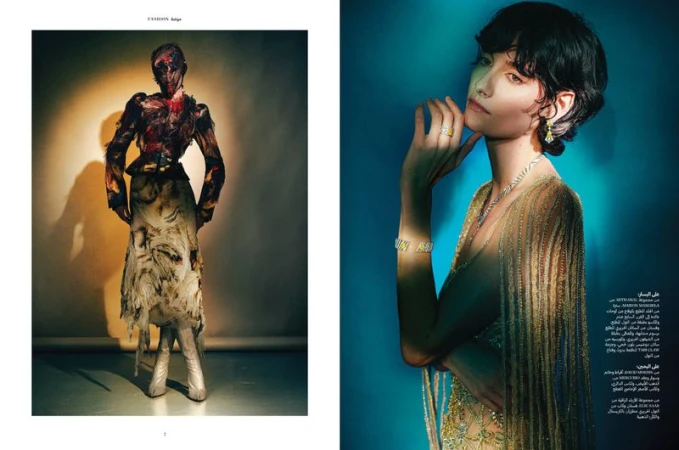 Two fashion models showcase avant-garde designs; one with feathered top and metallic boots, the other in beaded dress with jewelry.