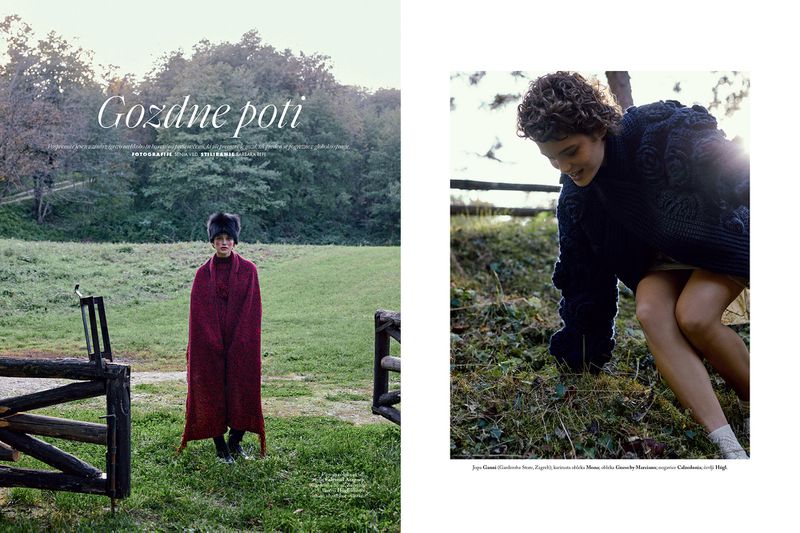Two fashion images: one woman stands in a field wearing a burgundy cape and fur hat; the other wears a dark sweater and no pants.