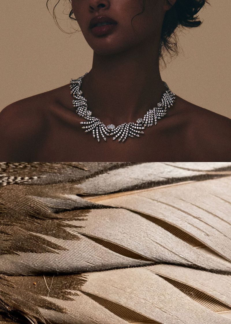 Striking close-up showcases an elegant necklace on a woman with soft feathers underneath, creating a unique blend of beauty and nature.