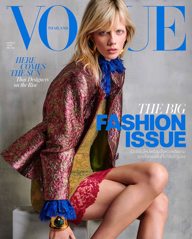 Vogue Thailand magazine cover featuring a blonde fashion model wearing a patterned jacket, green top, and jewel-toned bracelet.