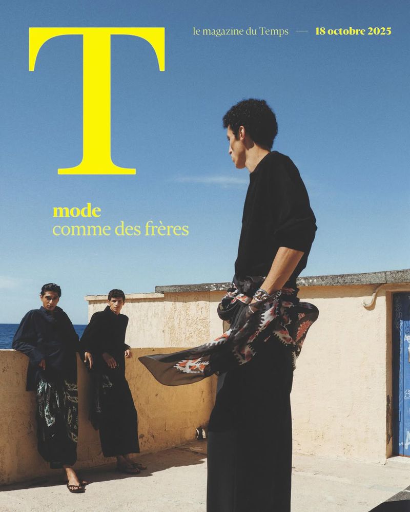 Fashion magazine cover featuring three young adult male models in black clothing and patterned skirts against a sunny outdoor backdrop.