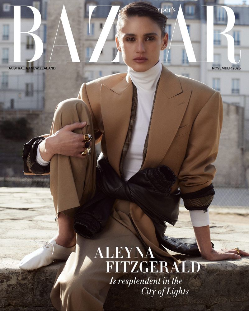 Model Aleyna Fitzgerald in a camel blazer and white turtleneck seated outdoors for the cover of Harper's Bazaar Australia.