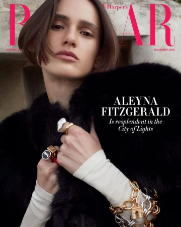 Harper's Bazaar cover featuring a model wearing a black fur coat and jewelry, with magazine text overlayed on a neutral stone background.