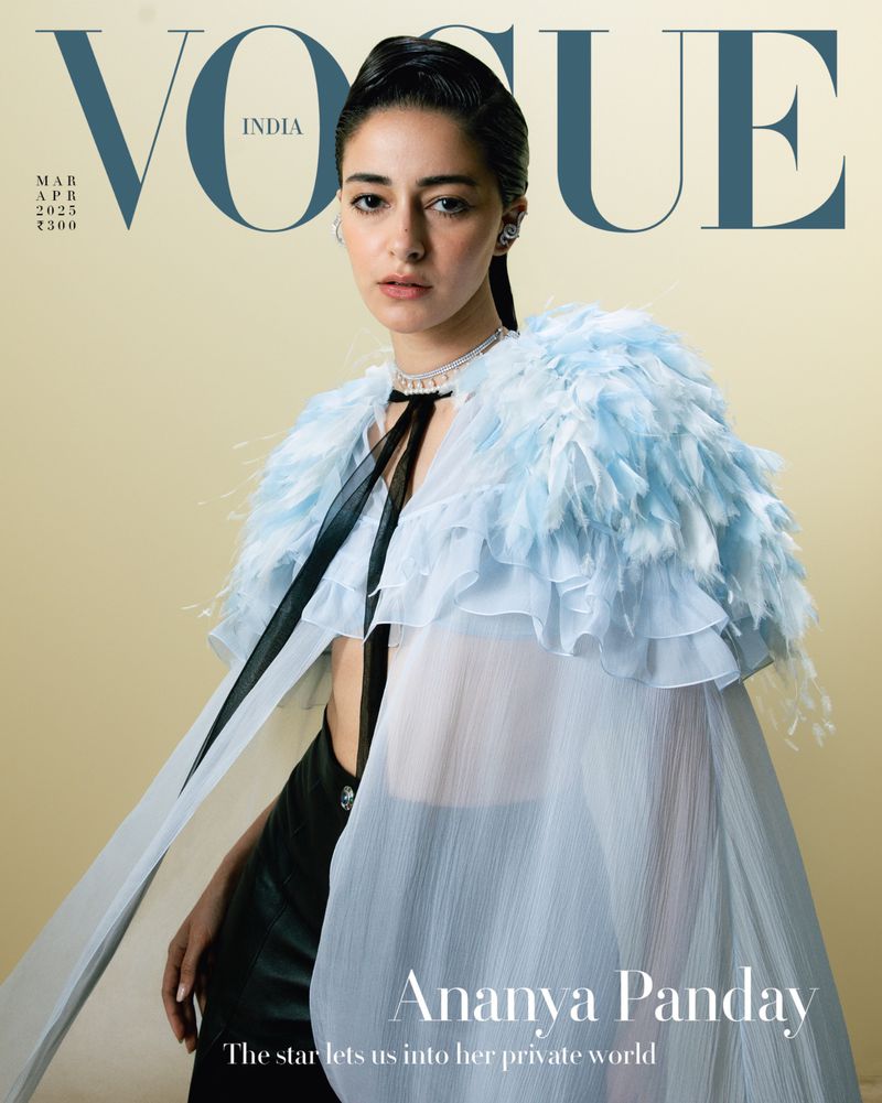 Vogue India cover featuring Ananya Panday in a light blue feathered cape and black outfit against a beige backdrop.