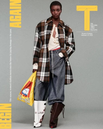 Editorial fashion shot of a Black female model wearing a plaid coat, baggy jeans, and mismatched boots, holding a yellow tote bag.