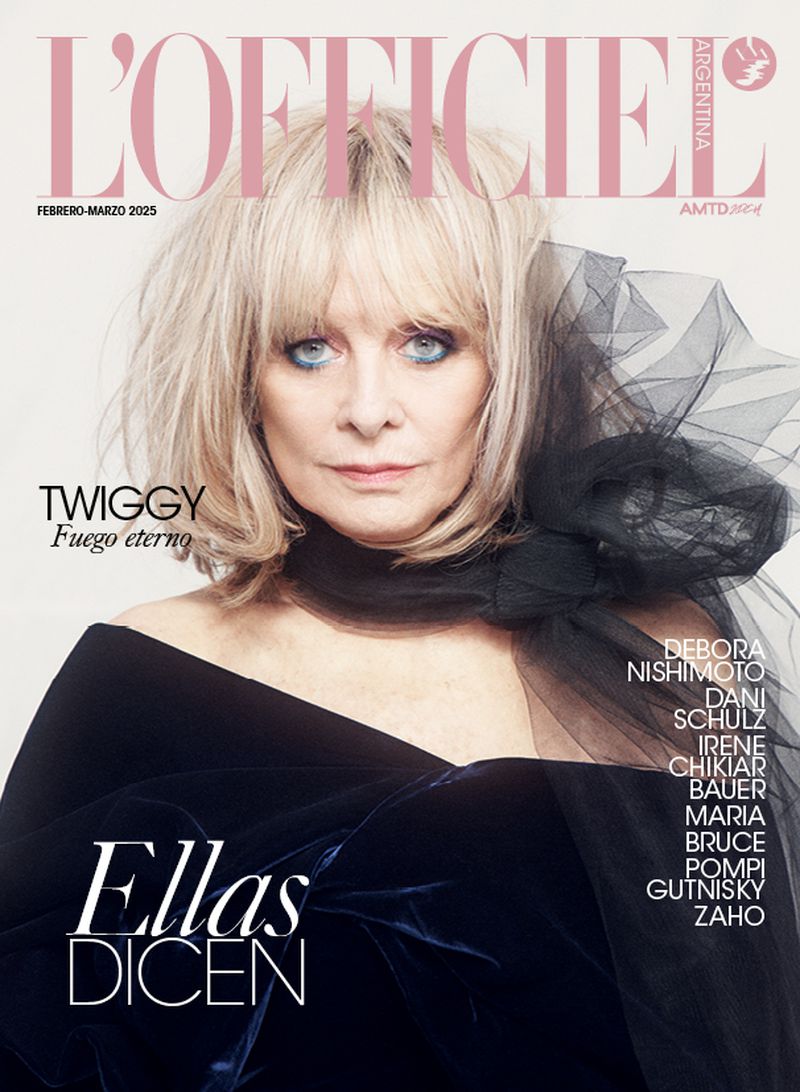 Magazine cover featuring Twiggy with blonde hair and blue eyes wearing a black dress and black netting, against a light beige background.