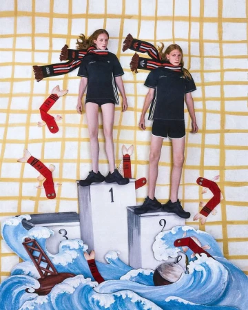 Two models standing on a podium wearing black athletic apparel and striped scarves against a painted backdrop.