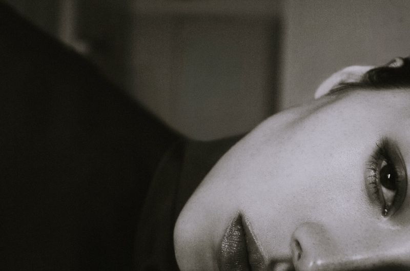 Close-up monochrome portrait of a model in profile against an interior background