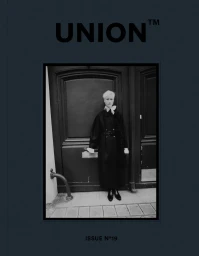 Black and white editorial portrait of a model standing before paneled double doors for Union Magazine issue 19.