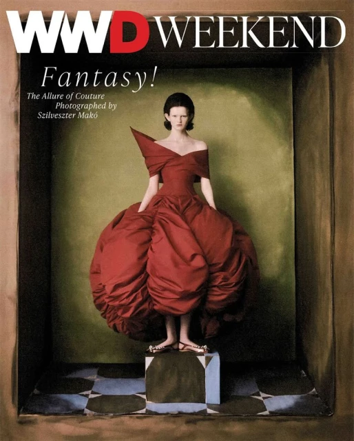 Fashion editorial featuring a model in a red couture dress and minimalist background. The image is a magazine cover.
