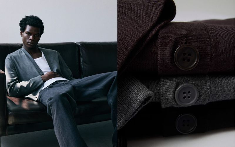 An adult male model lounges on a dark brown leather couch. He is wearing dark wash jeans, white t-shirt and a gray cardigan.