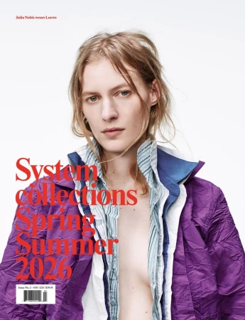Fashion magazine cover featuring a fair-skinned adult woman in a purple jacket, captured in a medium shot against a white background.