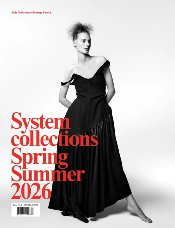 Fashion magazine cover featuring a woman in an off-the-shoulder black dress against a clean white background with bold red typography.