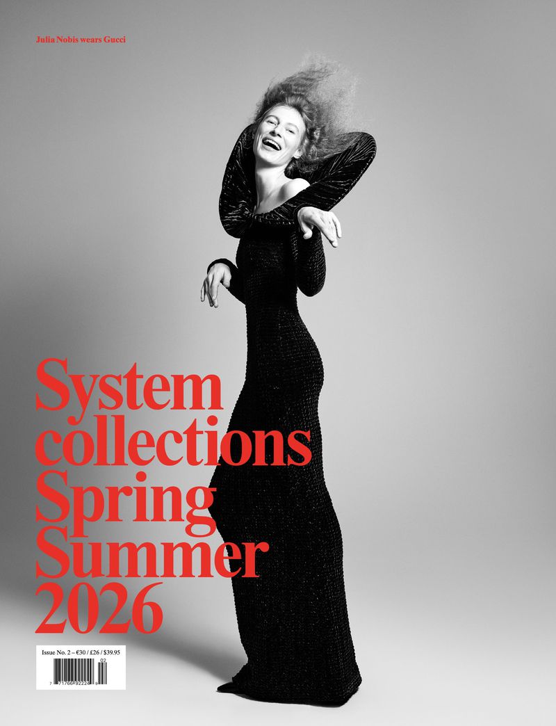 Magazine cover featuring a woman in a black dress laughing. The cover includes the text 'System collections Spring Summer 2026'.