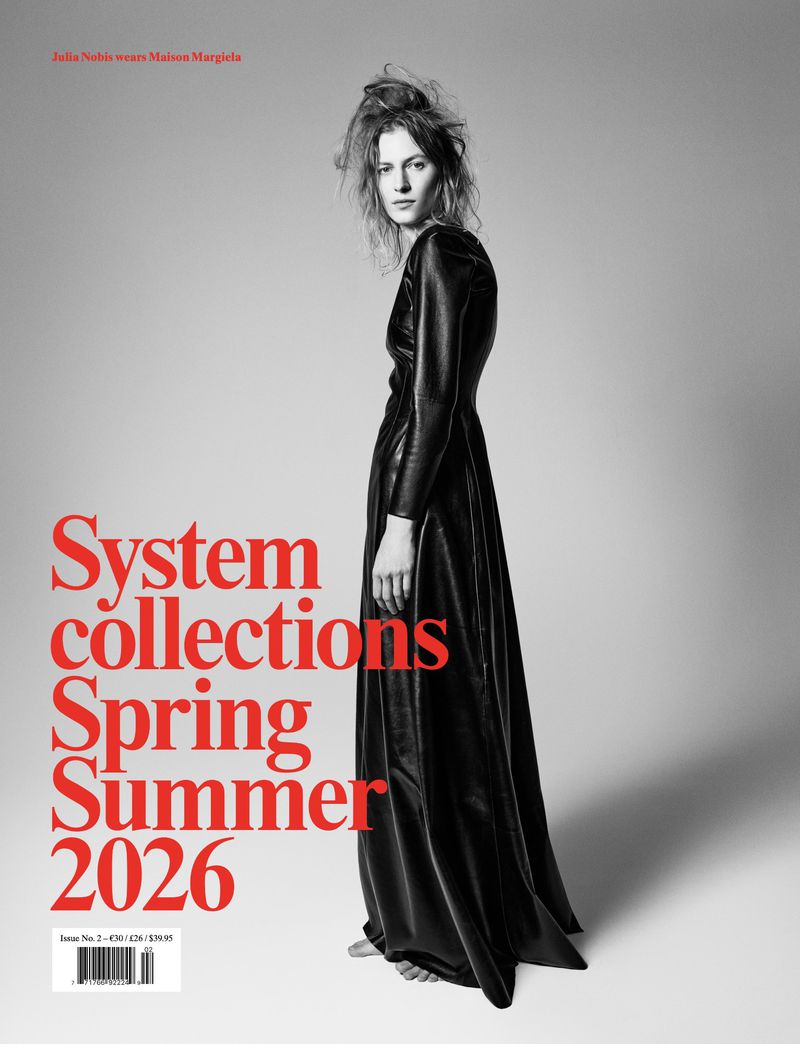 Fashion editorial shot of an adult female wearing a long black dress, posing in a studio setting with red text overlay.