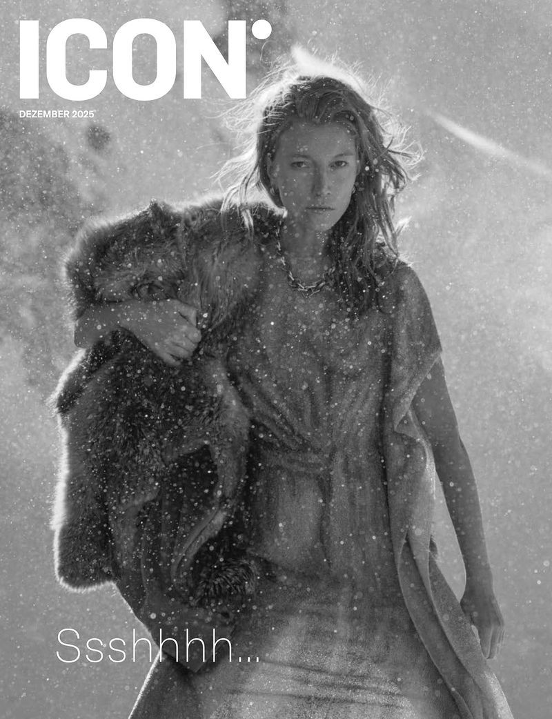 Black-and-white magazine cover featuring a woman in a dress, draped with fur, amidst a snowy environment, with the ICON logo.