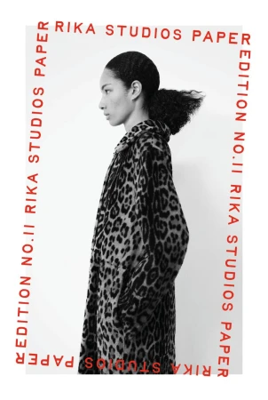 Black and white profile portrait of a woman in a leopard print coat bordered by red Rika Studios Paper text on a white backdrop.