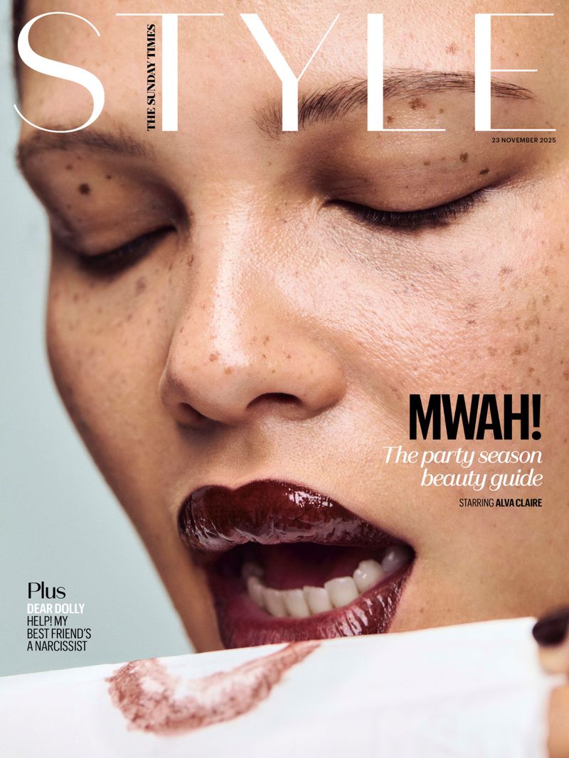 Magazine cover featuring a close-up of a woman's face with freckles, dark lipstick, and closed eyes, promoting a beauty guide for the party season.