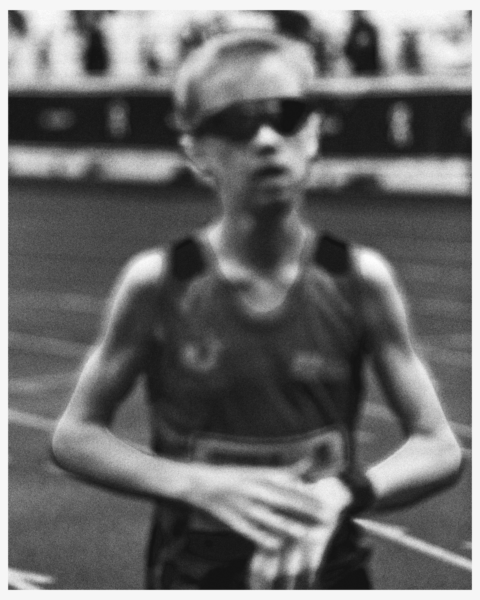 Runner in athletic tank top and sunglasses on a track for On Zatopek 10 by Julian Schulz