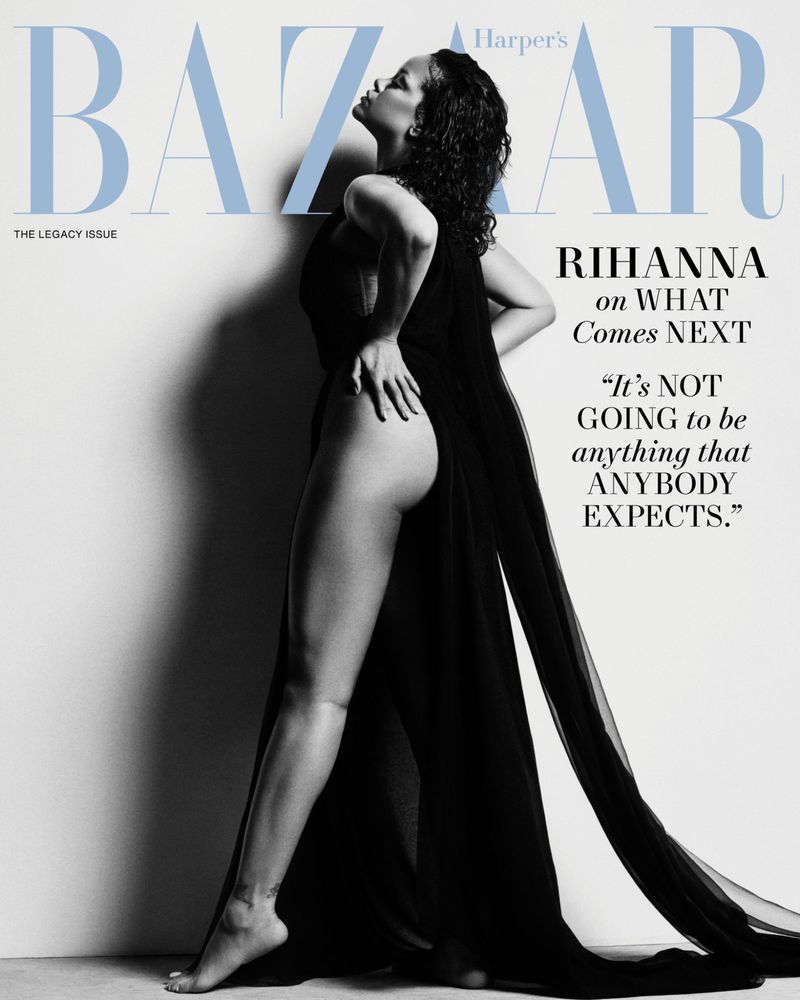 Black and white portrait of Rihanna on the cover of Harper's Bazaar 'The Legacy Issue' with her hair wet and wearing a sheer black garment.