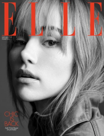 Elle magazine cover featuring a close-up shot of a woman with blonde hair and a denim jacket against a grey backdrop, with red lettering.