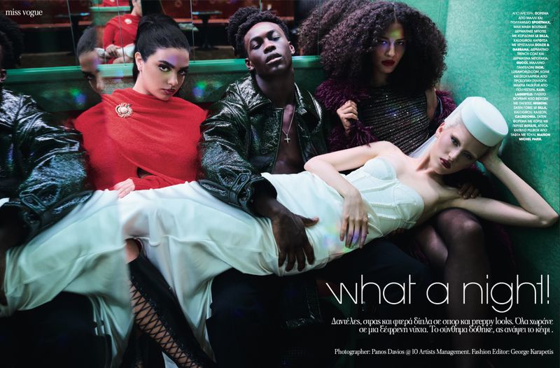 High-fashion editorial shot featuring five diverse models wearing elegant clothing and makeup, posing indoors with green lighting.