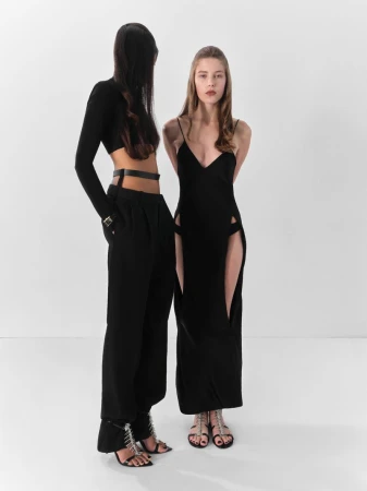 Two models posing in black cutout and tailored garments against a white seamless studio backdrop for Beyond Noise.