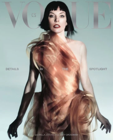 Vogue cover featuring Milla Jovovich wearing a flowing, peach-colored dress with silver Vogue logo and text details against a light blue backdrop.