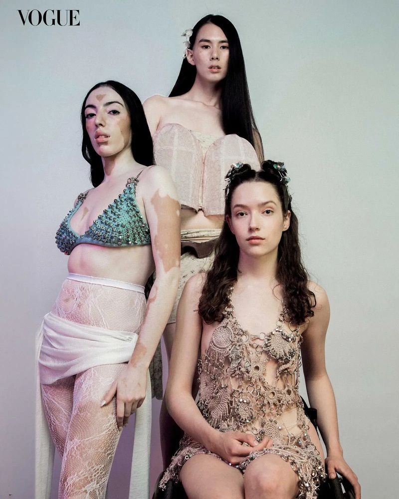 Three female models posing for a fashion portrait against a neutral grey studio background for Vogue Philippines diversity project