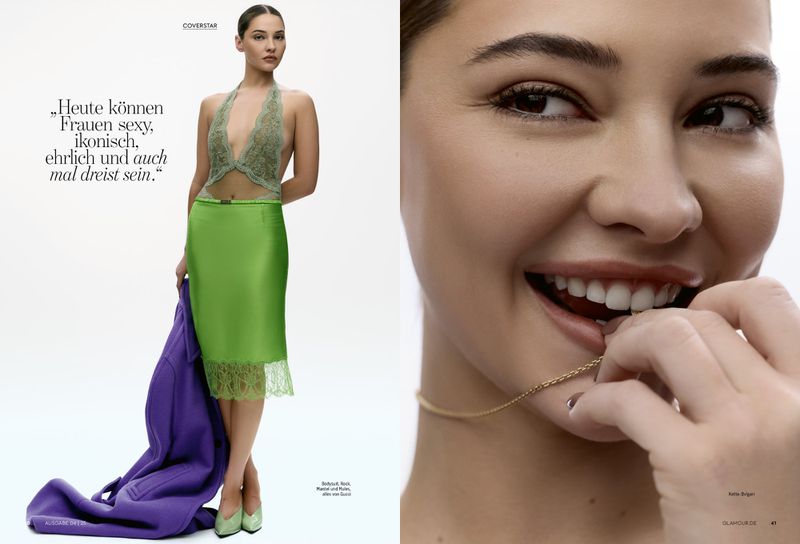 Glamour editorial shot: woman in green halter top and skirt poses with purple coat; close-up shows her holding a necklace and smiling.