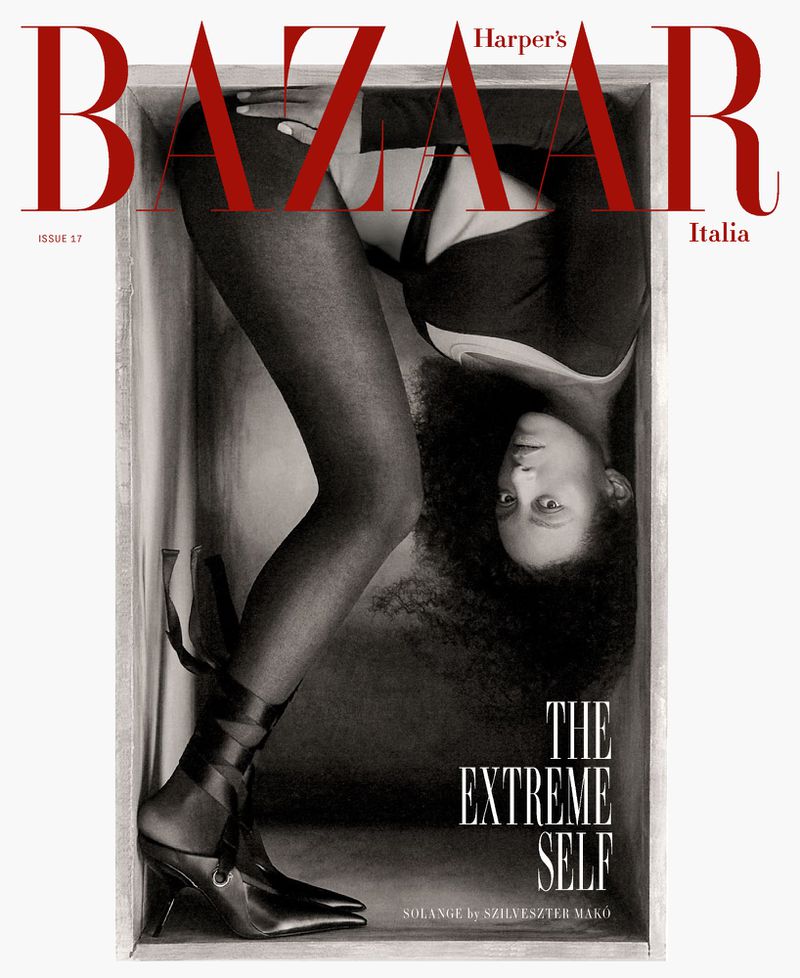 Harper's Bazaar Italia magazine cover featuring a Black woman in black attire posed inside a box with a shoe, artistic lighting.