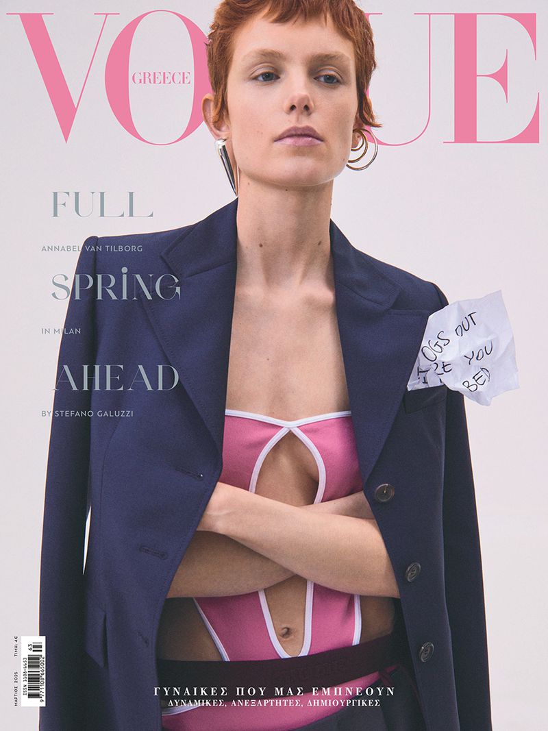 Vogue Greece magazine cover featuring a model in a pink top and navy blazer, with handwritten note attached to the blazer.