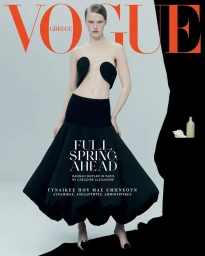 Hannah Motler in black avant-garde strapless top and full skirt against a seamless light grey background for Vogue Greece March 2025.