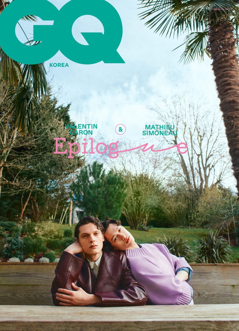 Magazine cover with two young men sitting on a wooden surface in a garden setting, with GQ Korea logo and masthead text visible.