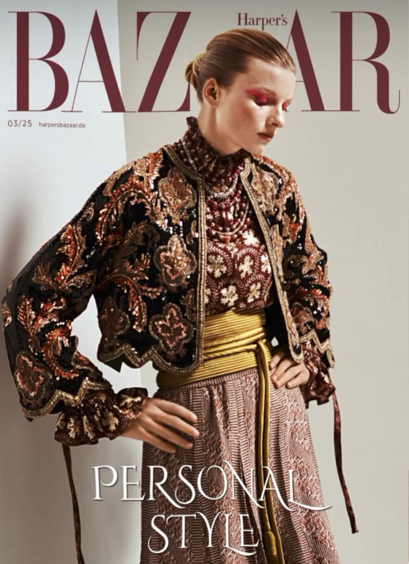 Fashion editorial cover of Harper's Bazaar magazine featuring a model wearing a sequined jacket and skirt with a gold belt against a neutral backdrop.