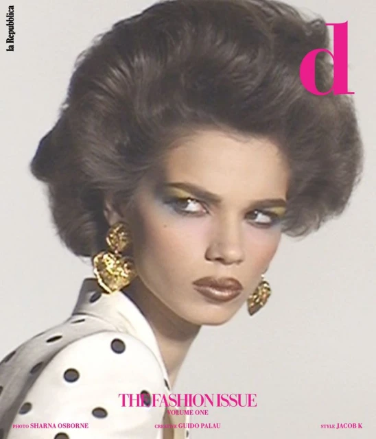Fashion magazine cover featuring a woman with brown hair, gold earrings, and polka dot clothing against a white background. Editorial shot.