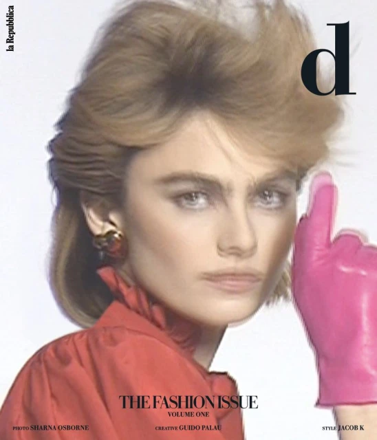 Fashion magazine cover featuring a model with a striking gaze, accentuated by a pink gloved hand near her face, promoting 'The Fashion Issue'.