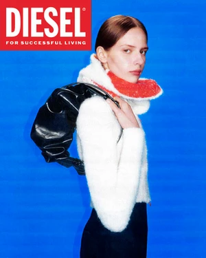 Model in white fuzzy sweater and dark skirt holding black handbag against a bright blue background for Diesel campaign