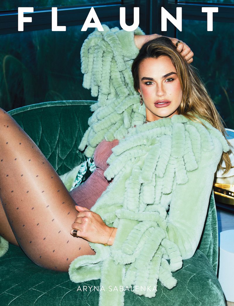 Fashion magazine cover features a model reclining on a green velvet couch wearing patterned tights and a light green fringe jacket.