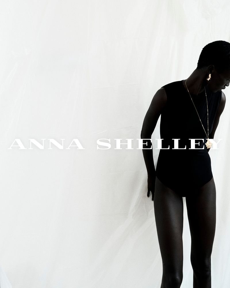 Model wearing a black sleeveless top against a bright white background with overlay text