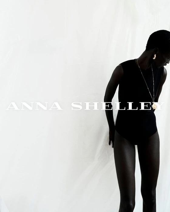 Model wearing a black sleeveless top against a bright white background with overlay text