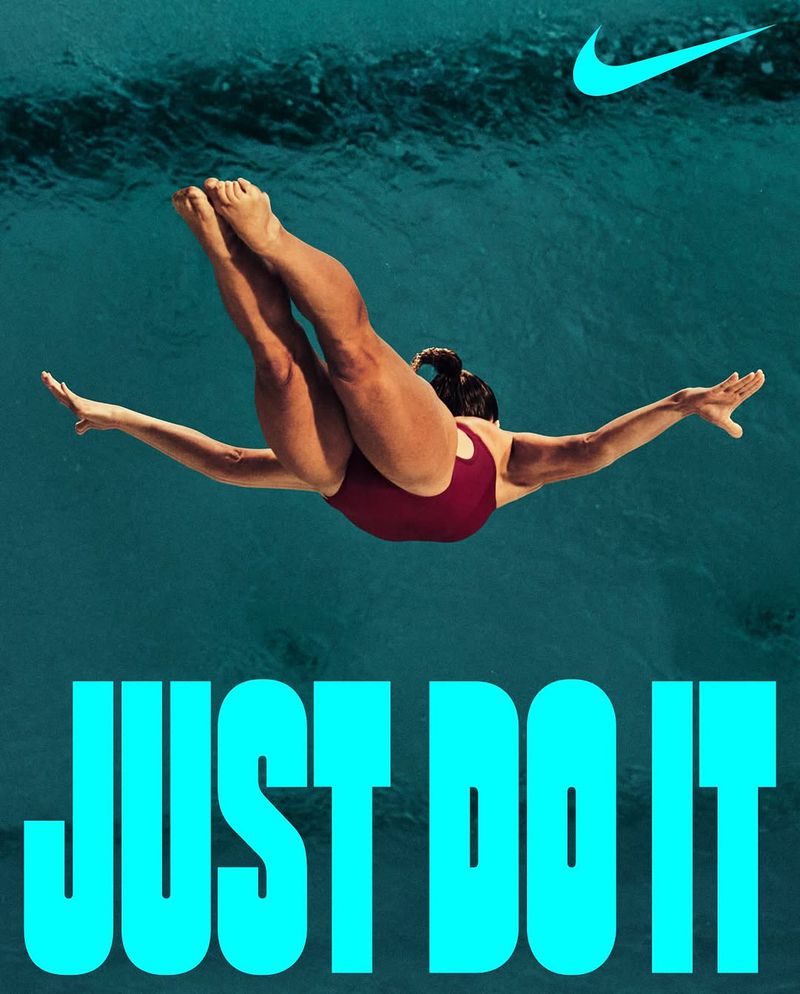Athletic woman dives into a pool of blue water in a Nike advertisement featuring the tagline, 'JUST DO IT' and the Nike swoosh logo.