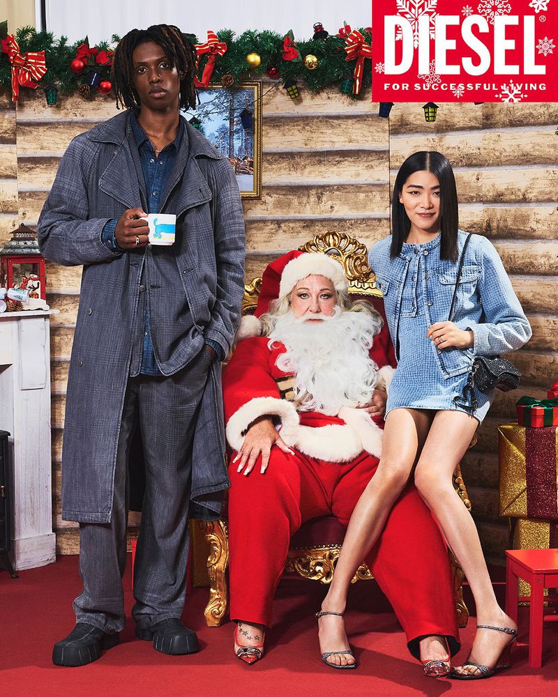 Fashion ad featuring a Black man, a white Santa Claus, and an Asian woman, all in denim outfits, posing in a Christmas-themed setting.
