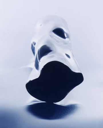 Abstract view of light and dark blue liquid on a white surface, creating a surreal and intriguing visual texture and form.