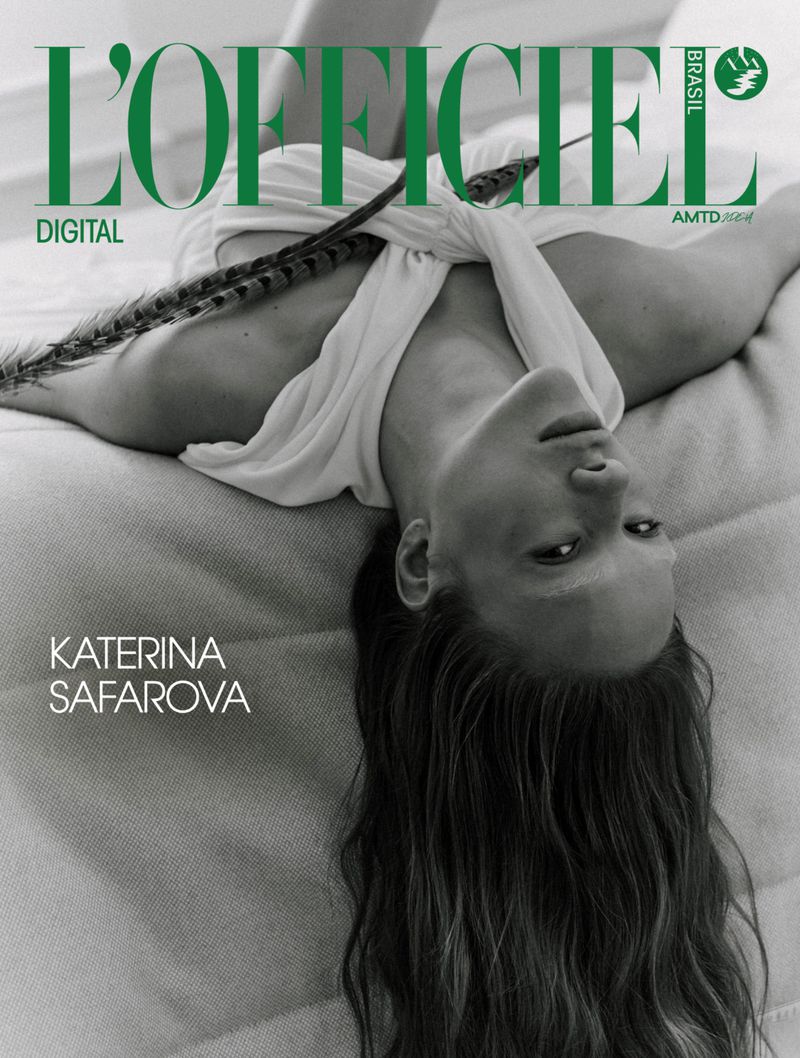 Magazine cover featuring a woman lying down with an elegant feather, green masthead with the name L'Officiel, and the name Katerina Safarova.