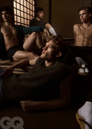 Four male models posing in a dimly lit interior setting with shoji screens for GQ Mexico winter trends editorial