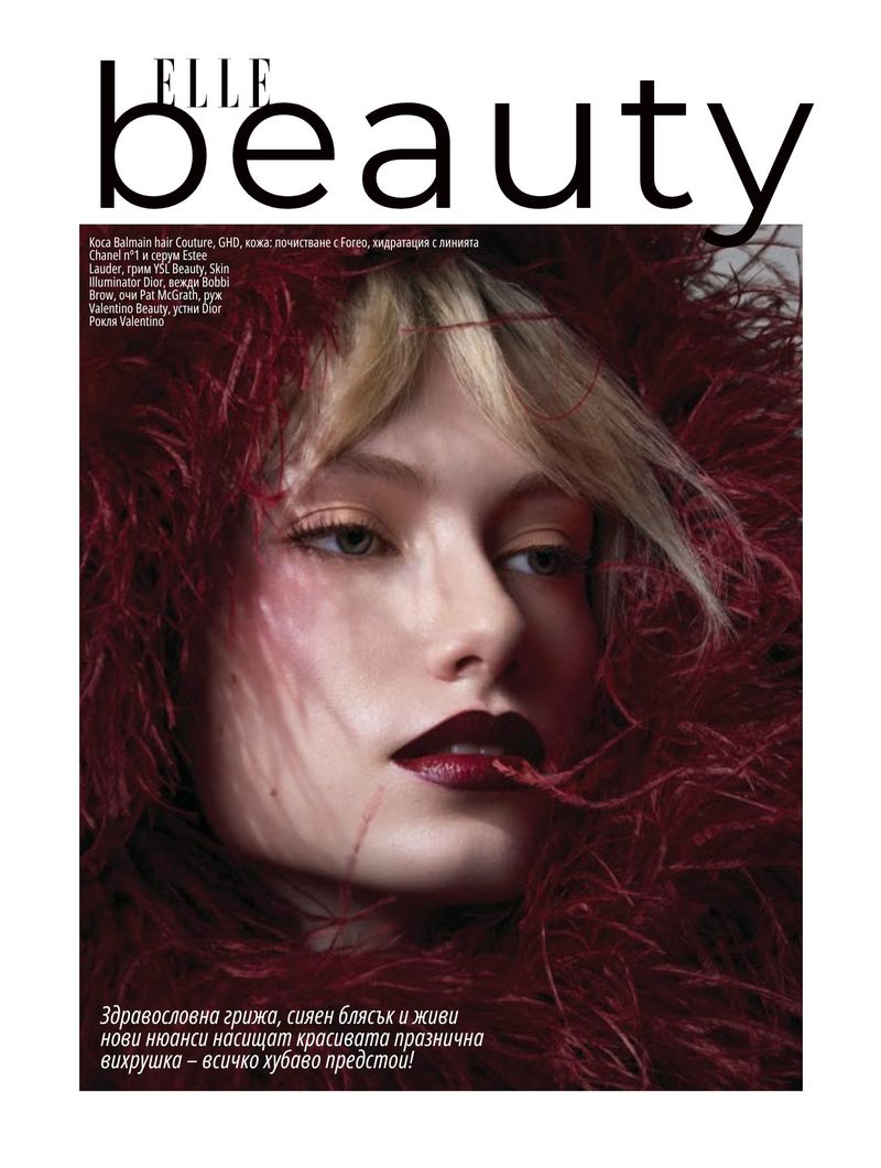Elle Beauty cover featuring a model surrounded by burgundy feathers, heavy makeup, and the magazine's text overlay.
